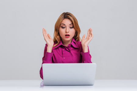 Young businesswoman working at laptop computer. she was surprised, printsの写真素材