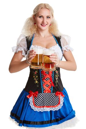 Beautiful young blond girl in dirndl drinks out of oktoberfest beer stein. Isolated on white background. she holds a glass with a drink and smilingの写真素材
