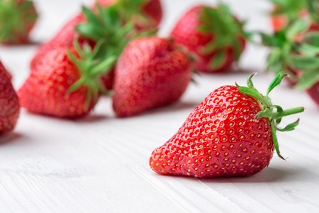 Red Strawberry, red close up strawberries with selective focus on a strawberry with many strawberries in the background for food or fruit close up background or strawberry texture.の写真素材