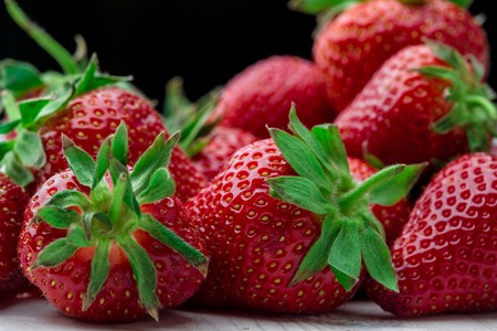Red Strawberry, red close up strawberries with selective focus on a strawberry with many strawberries in the background for food or fruit close up background or strawberry texture.の写真素材