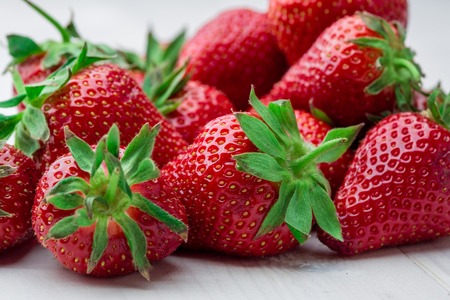 Red Strawberry, red close up strawberries with selective focus on a strawberry with many strawberries in the background for food or fruit close up background or strawberry texture.の写真素材