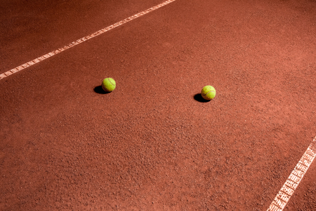 two tennis ball on the ground on the courtの写真素材