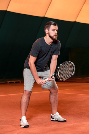 Man playing tennis and waiting for the serviceの写真素材
