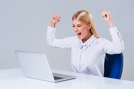 Young businesswoman working at laptop computer. she is happy pleasedの写真素材