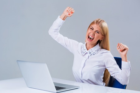 Young businesswoman working at laptop computer. she is happy pleasedの写真素材