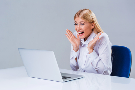 Young businesswoman working at laptop computer. surprised pleasedの写真素材