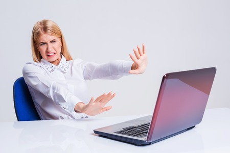 Young businesswoman working at laptop computer. pleasantly surprised dissatisfied girlの写真素材