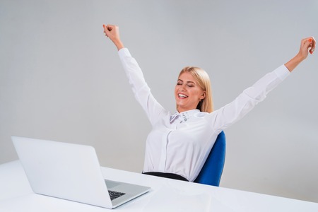 Young businesswoman working at laptop computer. surprised pleasedの写真素材