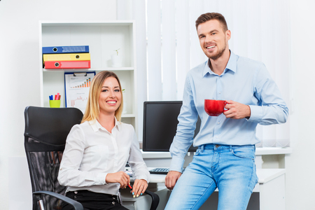 Happy smart business couple discussing. on office backgroundの写真素材