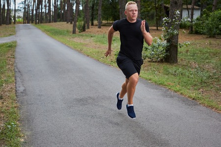 young athlete running in the forest, motion blurの写真素材