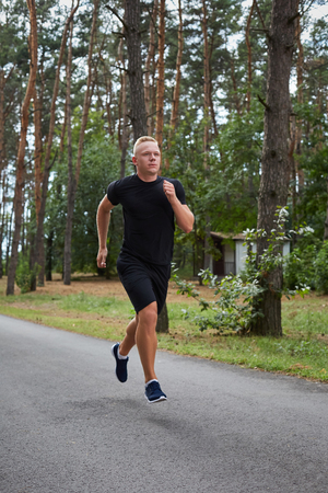 young athlete running in the forest, motion blurの写真素材
