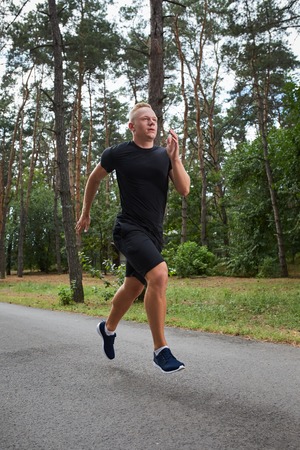 young athlete running in the forest, motion blurの写真素材