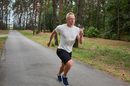 young athlete running in the forest, motion blurの写真素材