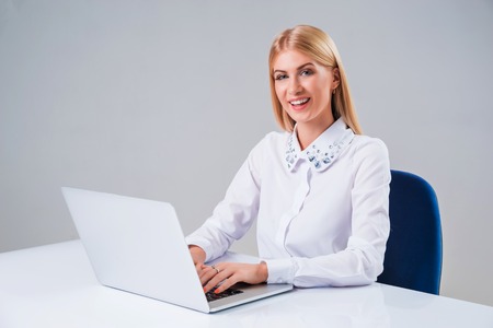 Young businesswoman working at laptop computer. she pleased, to do the work is happyの写真素材