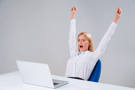 Young businesswoman working at laptop computer. she tired after work, yawnsの写真素材