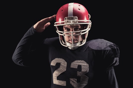 Soccer player on a dark background in vintage style. The classic American game. college Studentsの写真素材