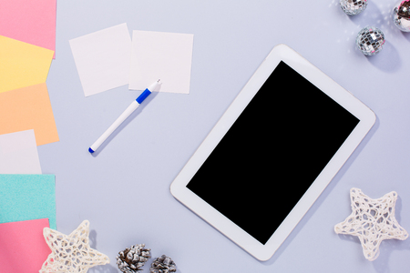 Smartphone with Christmas decorations. Christmas mock up template. View from above, gray backgroundの写真素材