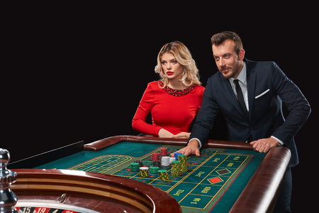 Couple playing roulette wins at the casino. Addiction to the gambling. he bets chipsの写真素材