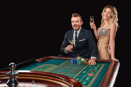 Couple playing roulette wins at the casino. Addiction to the gambling. happy winの写真素材