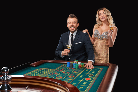 Couple playing roulette wins at the casino. Addiction to the gambling. happy winの写真素材
