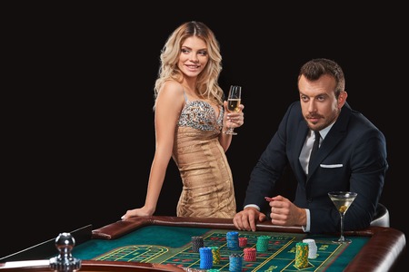 Couple playing roulette wins at the casino. Addiction to the gamblingの写真素材
