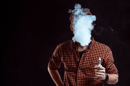young man smoking electronic cigarette