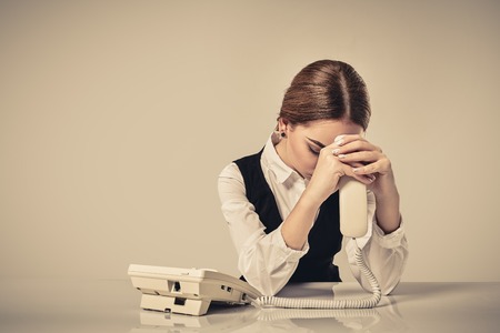 portrait of young secretary answering telephoneの写真素材