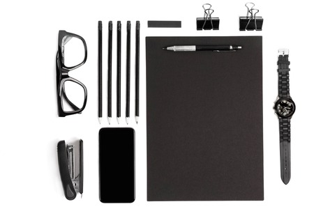 Blank notepad with clips, pens and glasses flat lay.の写真素材