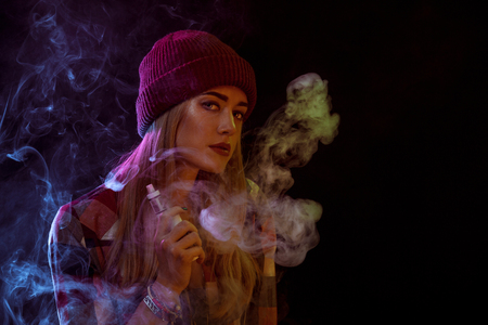 young woman smoking electronic cigarette
