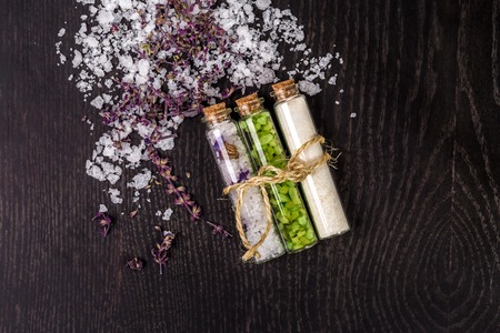 Glass jar with bath salts on black backgroundの写真素材