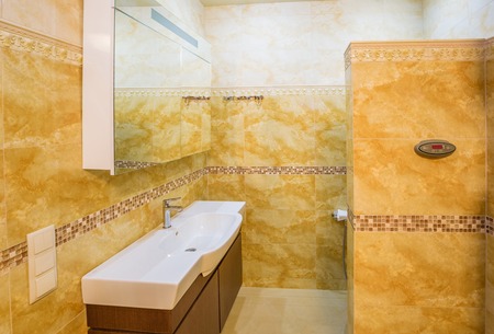 interior modern house, bathroom with marble tiles. Bathroom in beige tonesの写真素材