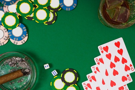 Set to playing poker with cards and chips on green backgroundの写真素材