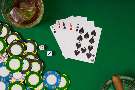 gambling, fortune and entertainment concept - close up of casino chips, whisky glass, playing cards...