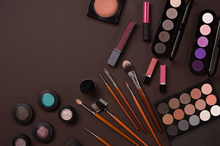 Top view on set of cosmetics for professional make-up on brown backgroundの写真素材