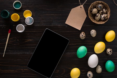 Greeting card with paschal eggs on rustic, wood tableの写真素材