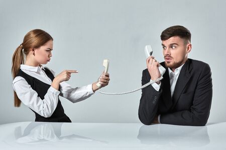 picture of man and woman with telephone at the table