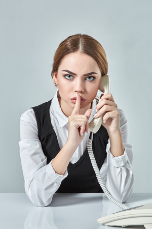 portrait of young secretary answering telephoneの写真素材