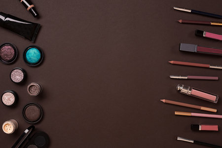 Make up essentials. Set of professional make up brushes, creams and shadows in jars on dark background. Place for your text or logo. Ideal for beauty blog.の写真素材