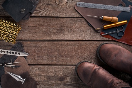 Leather handbag. Work place craftsman in a workshop. Place for your text or logo. Ideal for blog. Top viewの写真素材
