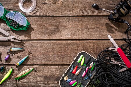 Accessories for fishing on the background of wood. Top viewの写真素材