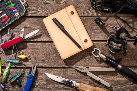 Accessories for fishing on the background of wood. Top viewの写真素材