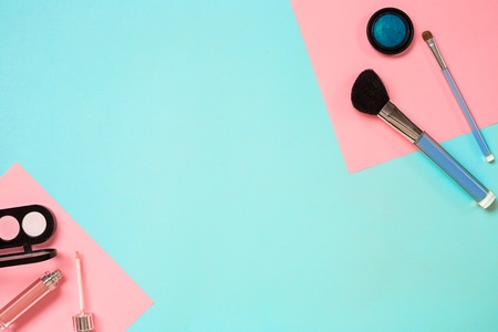Make up essentials. Set of professional make up brushes, creams and shadows in jars on blue background. Place for your text or logo. Ideal for beauty blog.の写真素材