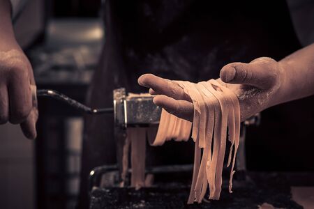 The chef makes fresh spaghetti from scratch.の写真素材