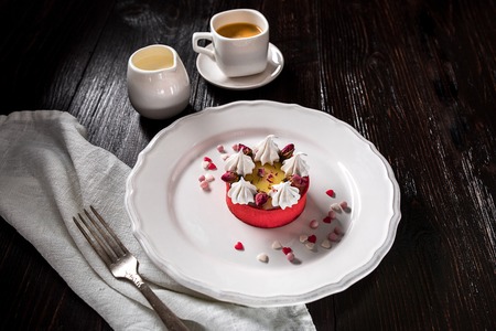 Caramel cheesecake with cream and flowers on the wooden backgroundの写真素材