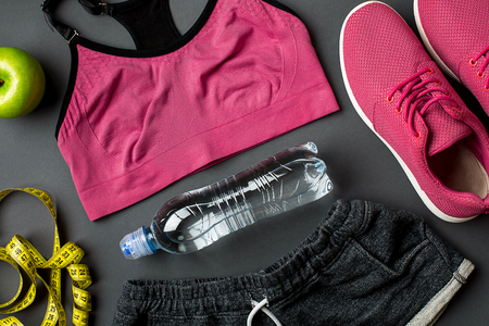 Workout plan with fitness food and sport equipment on gray background, top view. Copy space. Still lifeの写真素材