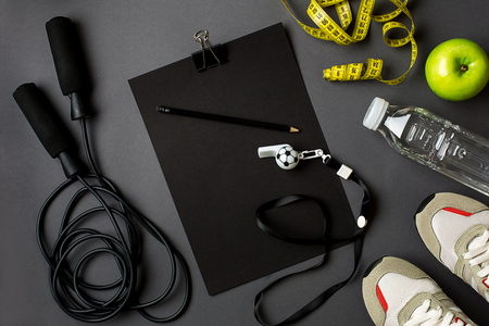 Workout plan with fitness food and sport equipment on gray background, top view. Copy space. Still lifeの写真素材