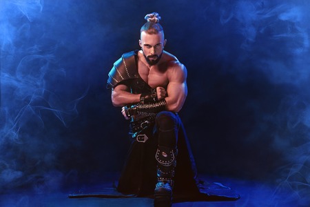 Handsome young sexy man with beautiful muscular chest in interesting costume on the scene. The Stripper man. Show timeの写真素材