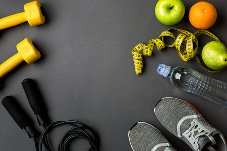 Workout plan with fitness food and sport equipment on gray background, top view. Copy space. Still life flat layの写真素材