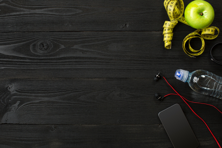 Workout plan with fitness equipment on dark background, top view. Copy space. Still lifeの写真素材