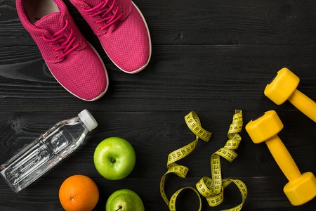 Workout plan with fitness food and equipment on dark background, top view. Copy space. Still lifeの写真素材
